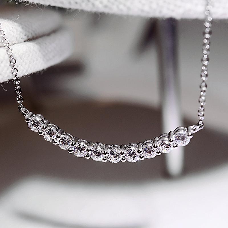 Curved smile pendant necklace, set with zircon stones