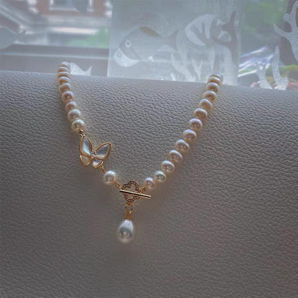 Designer-style necklace featuring natural freshwater pearls and a near-round, mother-of-pearl butterfly pendant 14k Gold-plated Sweet necklace with a