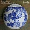 Hand-Painted Blue and White Ceramic Wall Vase with Floral and Bird Design