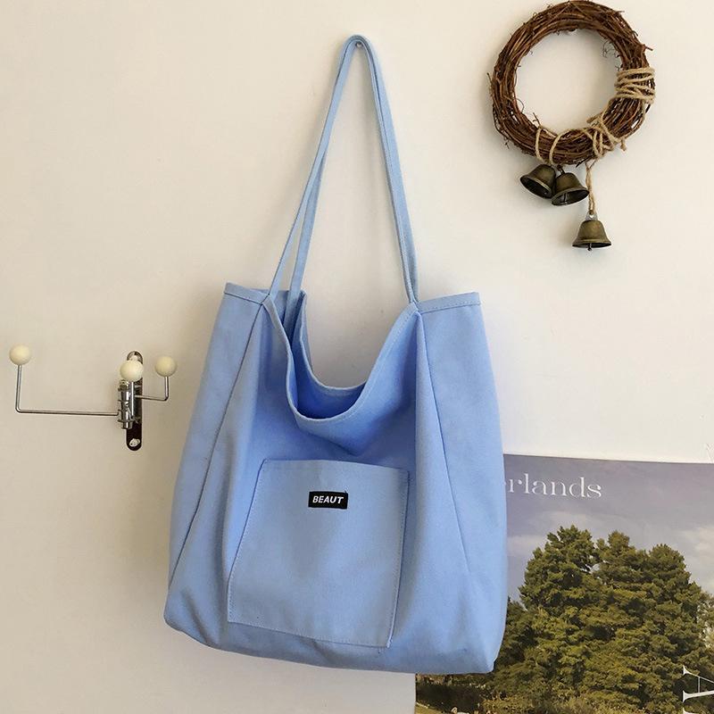Bolsa de lona com letra de cor sólida 2026 nova ins grande capacidade simples moderna bolsa de ombro versão coreana bolsa tote artística