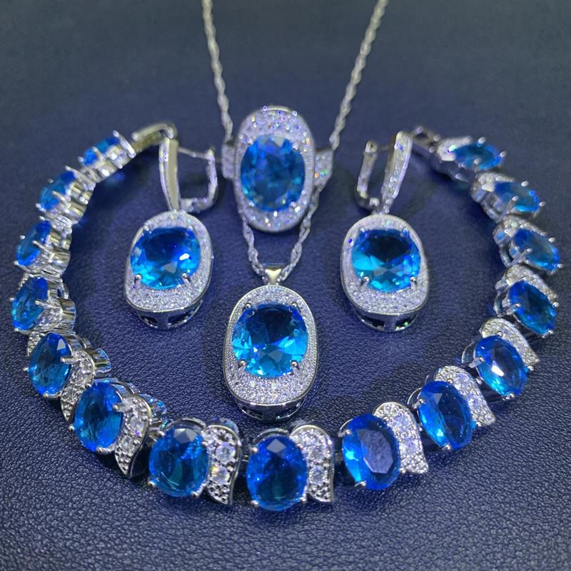 Čtyřdílná sada vykládaná světle modrým zirkonem Dámské náušnice náramek prsten Módní párty svatba