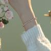 Super delicate, soft-toned orange, pink, and purple natural freshwater pearl bracelet with a small, bead-like design, elastic, and minimalist style