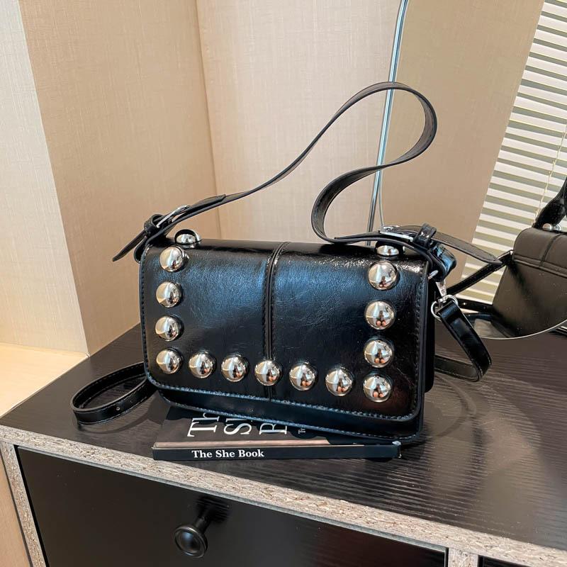 

Versatile locomotive wind messenger bag women s new rivet niche design sense single shoulder armpit small square bag чорний