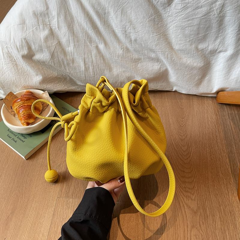 2026 New Drawstring Bucket Bag for Women Soft Leather Crossbody Bag with Ball Charm Mini Shoulder Handbag for Daily Shopping