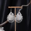 Bohemian Ethnic Miao Silver Tassel Earrings with Butterfly, Peacock, and Flower Design for Women – Long Dangle Jewelry for Travel Photos.
