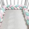 Three-strand knitted crib bumper, cable knit crib bumper
