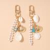 Hübscher Muschel-Schneckenhaus-Schlüsselanhänger Damen Perlen-Schlüsselring Handtaschen-Anhänger DIY-Schlüsselanhänger Schmuck Geschenke