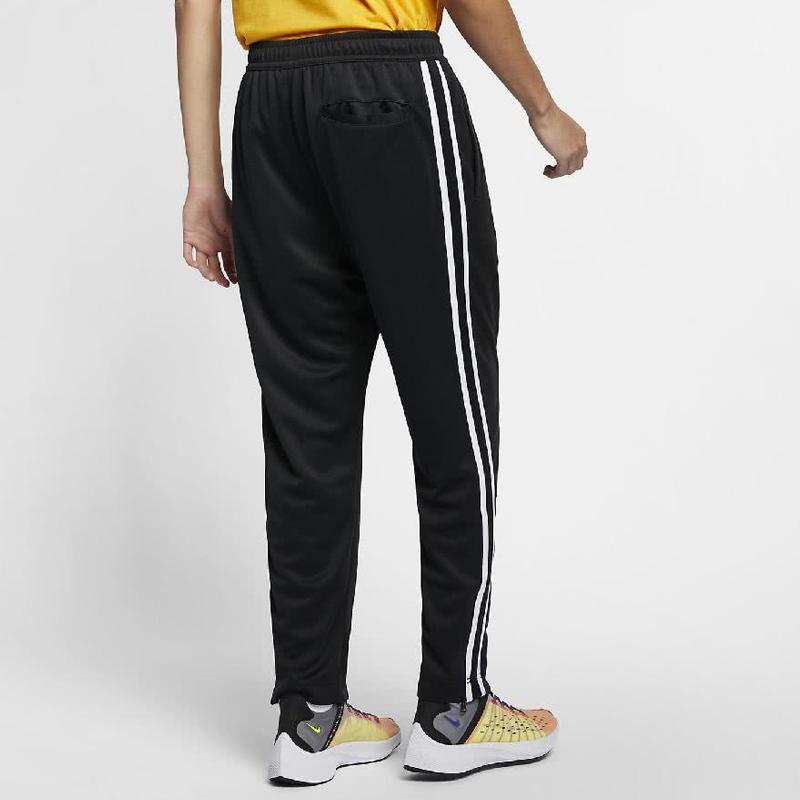 Nike Dzianinowe joggery męskie z lampasem bocznym i mankietami zapinanymi na zamek, czarne AR2247-010