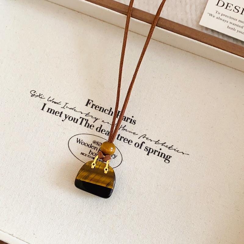 

Інфлюенсер Шкіряна Сумка для Монет та Навушників Намисто: Висококласний, універсальний ланцюжок для светра, модна біжутерія