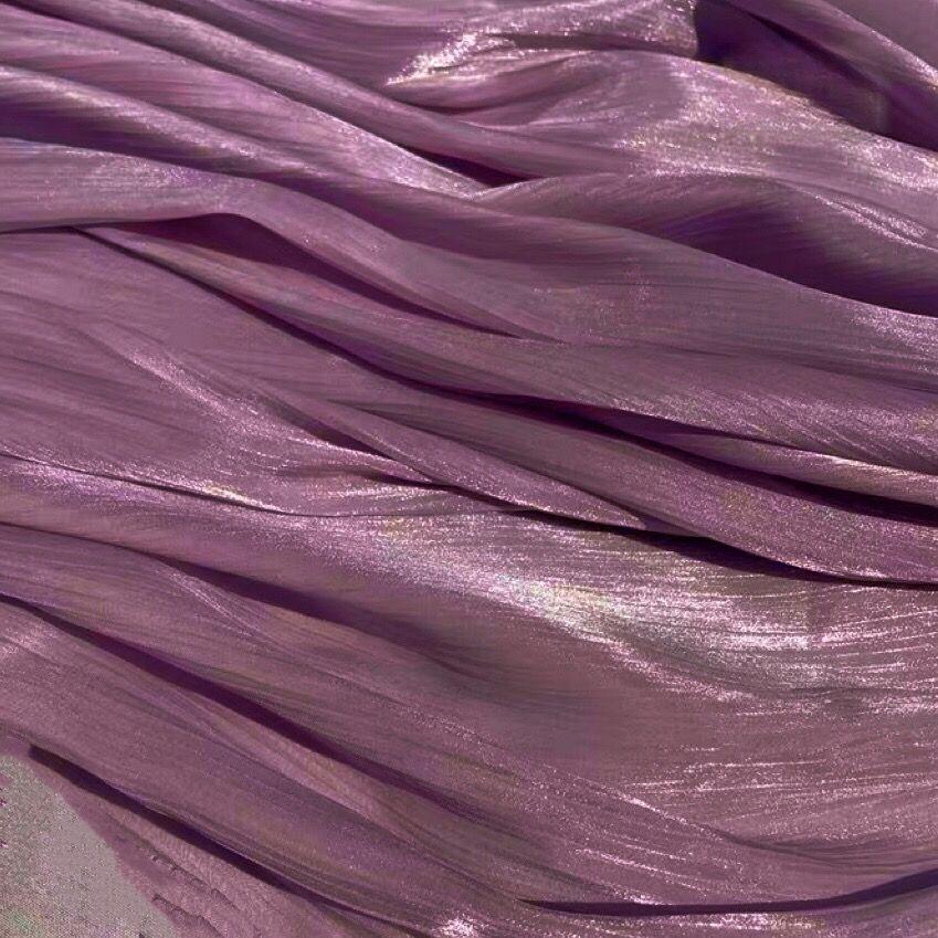 Soft shiny creased organza fabric with a smooth texture suitable for wedding dresses formal gowns and designer clothing fabrics