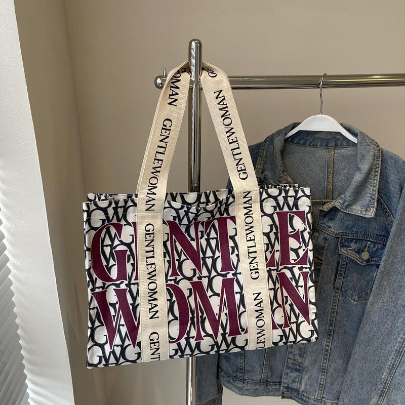 Large capacity alphabet canvas bag women's 2025 new fashion niche shoulder bag college student class commuter bag