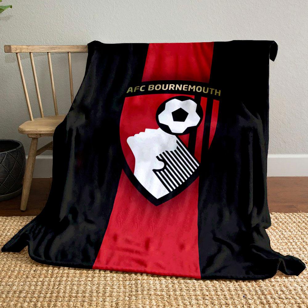 A shield with a soccer player heading a ball and vertical red stripes. for all seasons blanket lunch break throw gift
