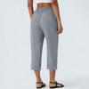 Pantaloni cropped larghi da donna in lino con elastico in vita, chiusura a bottone e tasche laterali per uso casual