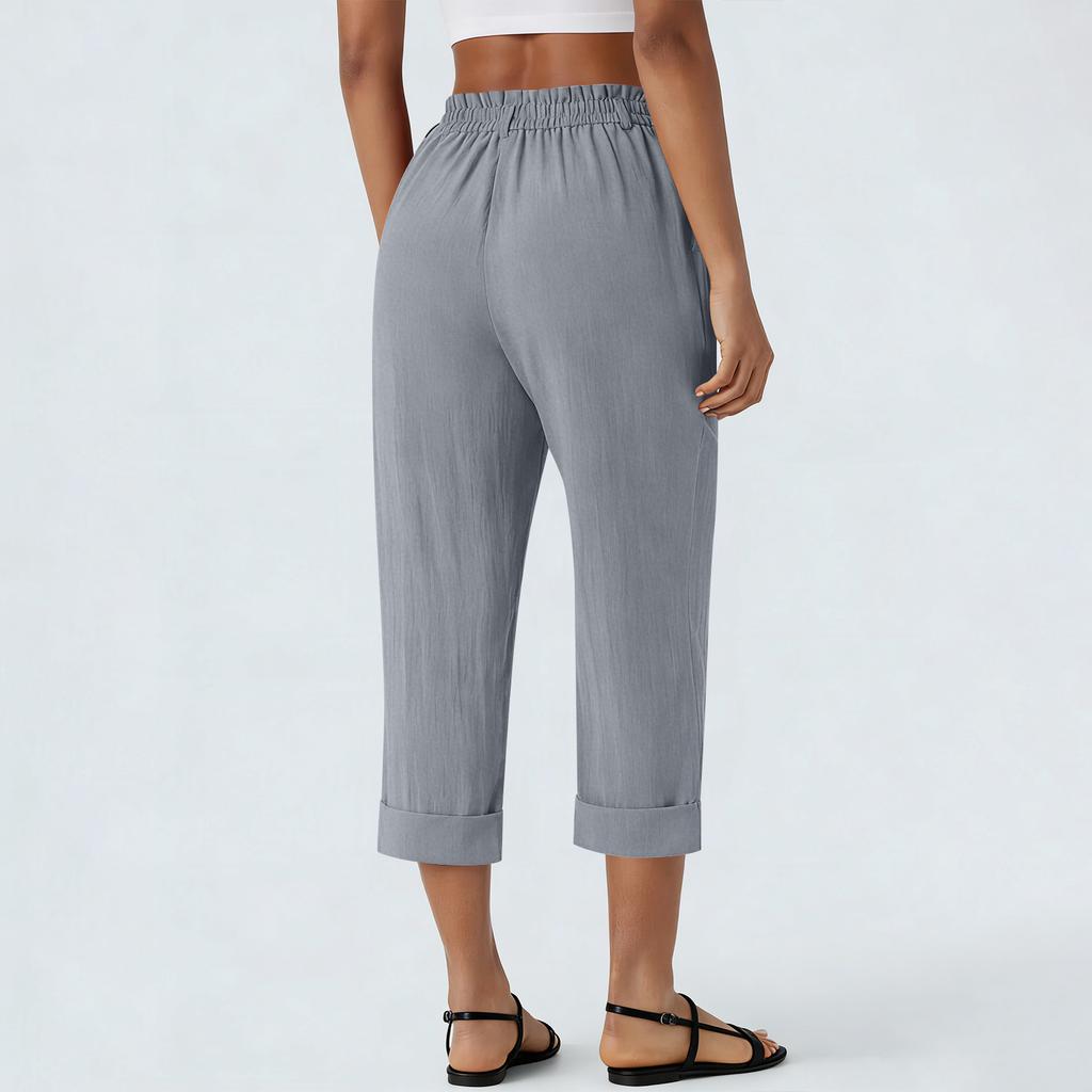 Pantaloni cropped larghi da donna in lino con elastico in vita, chiusura a bottone e tasche laterali per uso casual