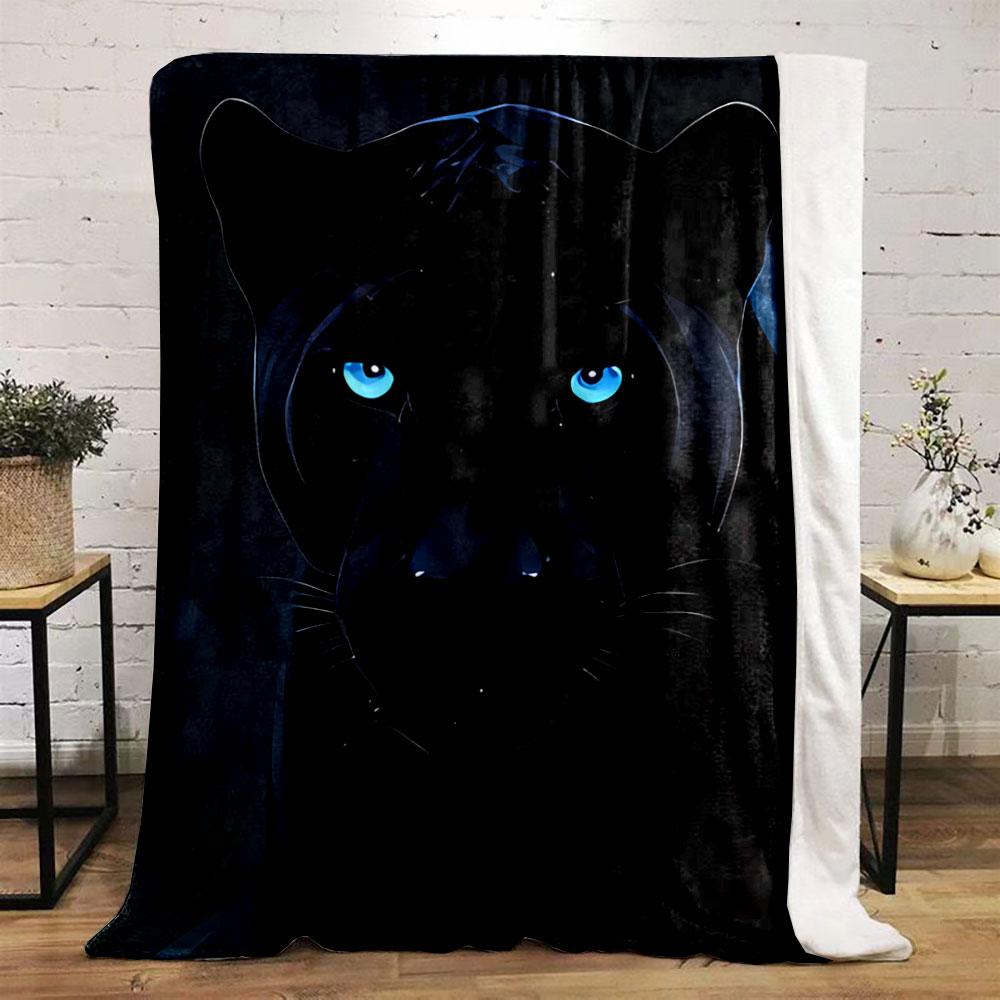 A sleek black panther with glowing blue eyes in a dark background. for all seasons blanket lunch break throw gift