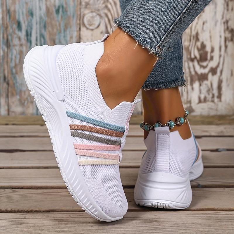 The Lady Wears Slip-On Casual Sports Shoes, Featuring a Breathable Mesh Design with Pastel Stripes, Suitable for Tennis And Comfortable