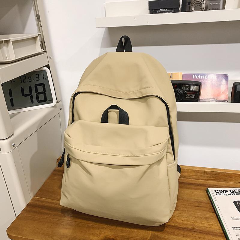 Casual large-capacity backpack fashionable outdoor lightweight junior high school students solid color simple schoolbag Korean version travel backpack