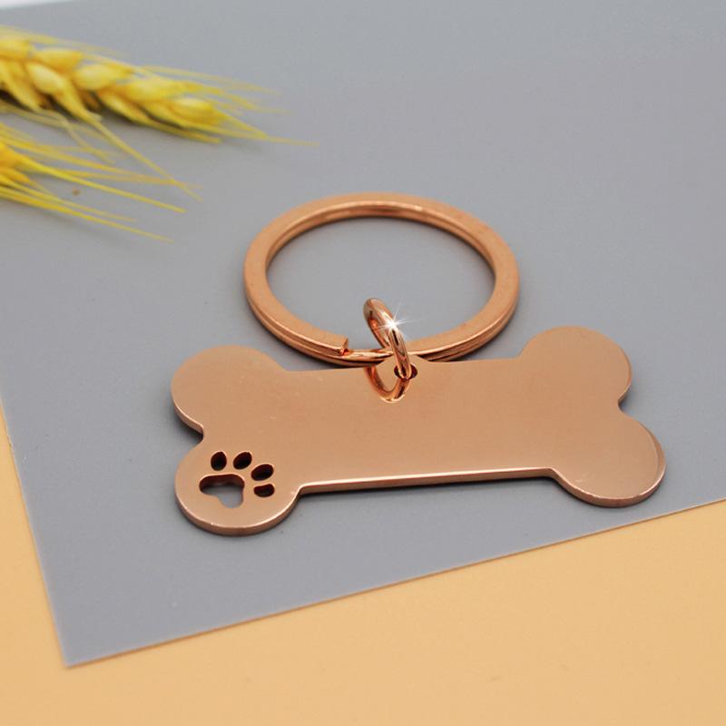 Hundemarke aus Edelstahl mit lasergraviertem Pfotenabdruck- und Knochendesign zur Haustieridentifizierung