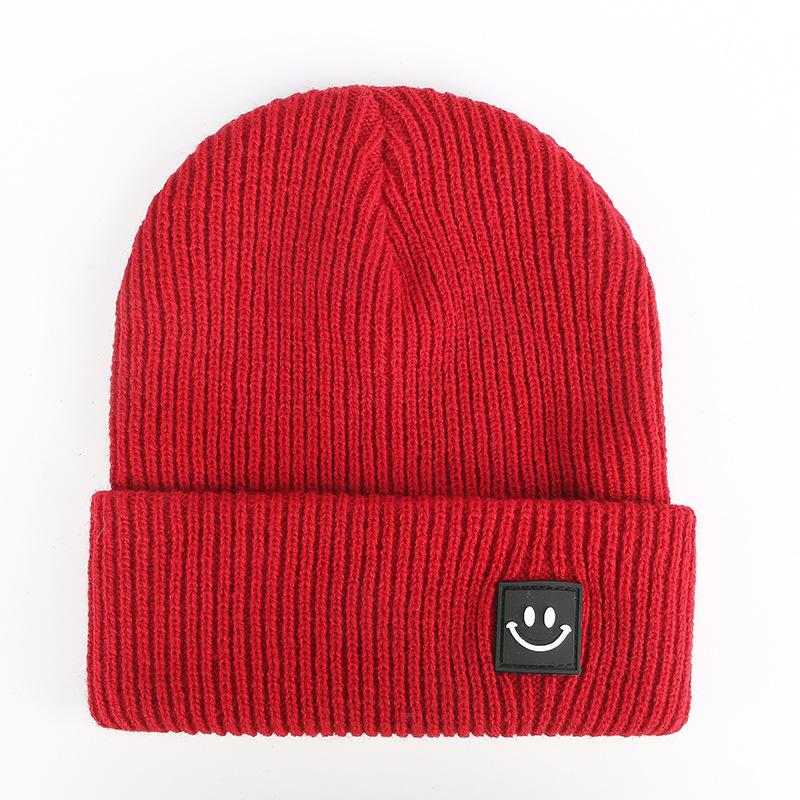 Autumn and winter smiley face labeling wool hat solid color couple versatile warm knitting classic casual hat men and women tide