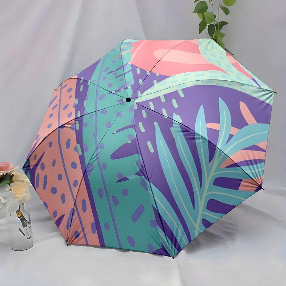 Folding Umbrella The umbrella features abstract tropical leaves and shapes in shades of purple, green, and peach. Fits Travel,