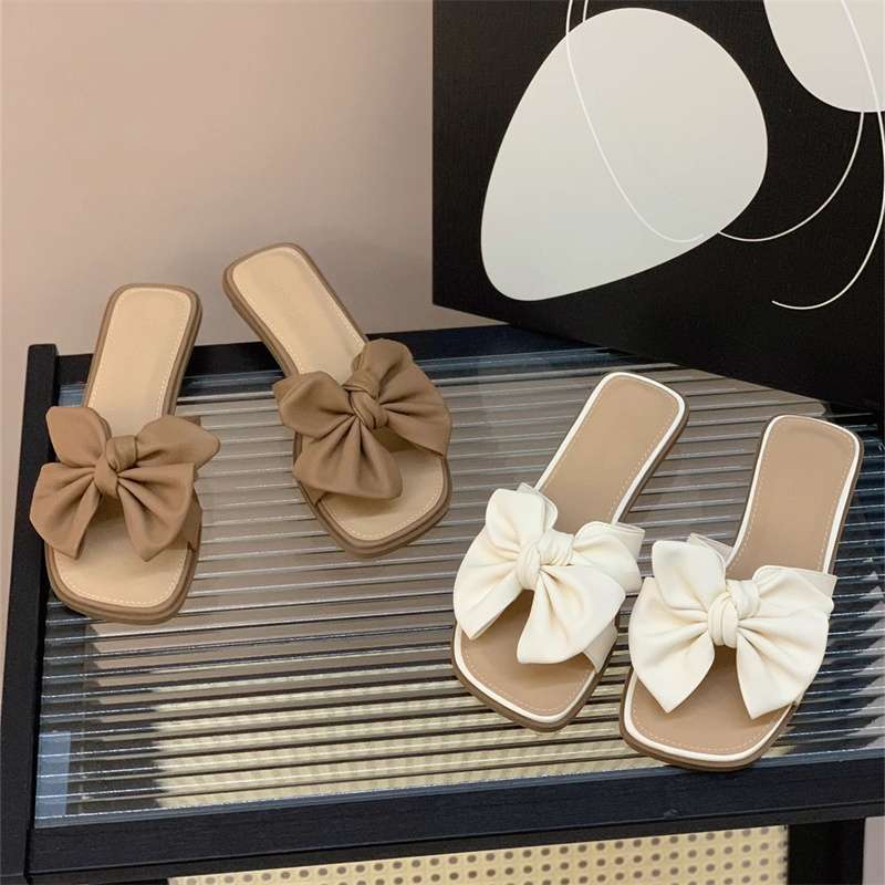 Low-heeled bow one-word drag women's summer wear flat-bottomed square-head slippers 2025 new seaside beach shoes