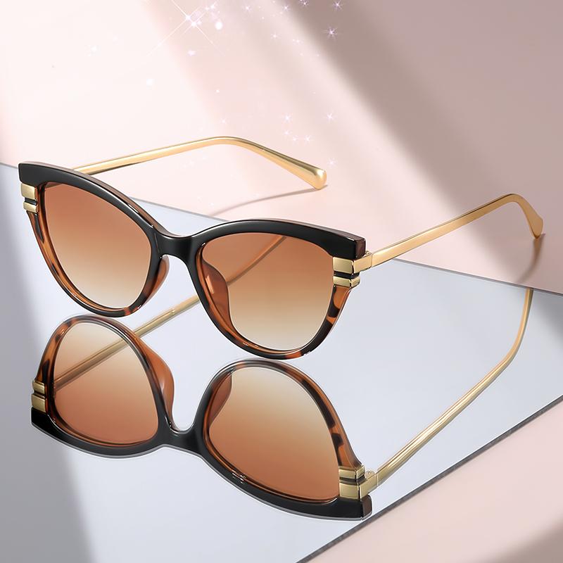 Fashion Cat Eye Sunglasses with Black Top Frame, Red Patterned Lower Frame, Gold Metal Arms, and Gradient Brown Lenses For