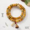 Pulsera de Topacio Crema Raíz Bodhi: Cuentas budistas unisex de doble círculo con motivos de ábaco y loto