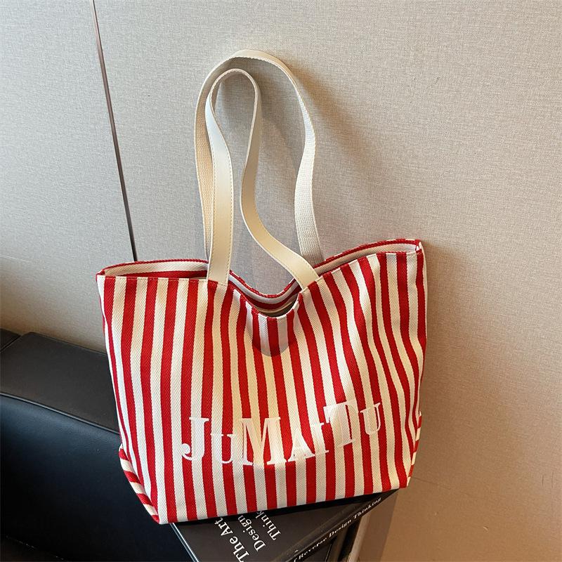 Niche design fashionable striped tote bag women's new large-capacity lazy wind shoulder bag canvas bag