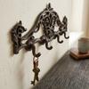 Two cast iron wall hangers, brown, decorated, decorative, 4 hooks