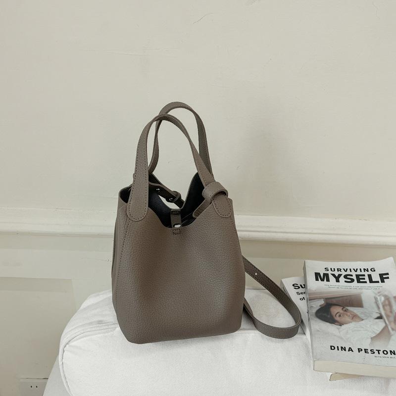 Borsa a secchiello dal feeling di nicchia, nuova borsa a mano da donna dall'atmosfera semplice, borsa a tracolla da pendolare da donna