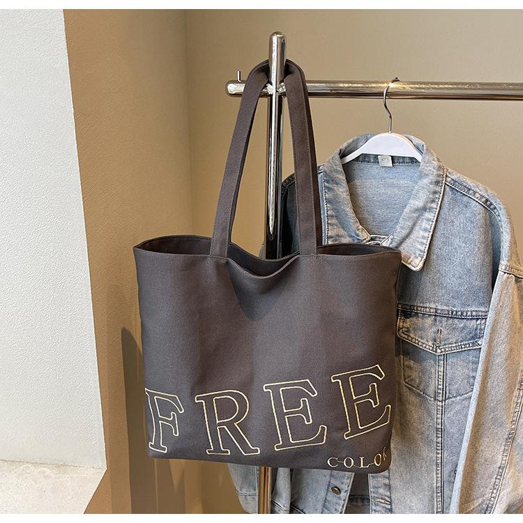 

2025 summer new letter cloth bag simple solid color fashion printing large capacity lazy wind shoulder tote bag серый