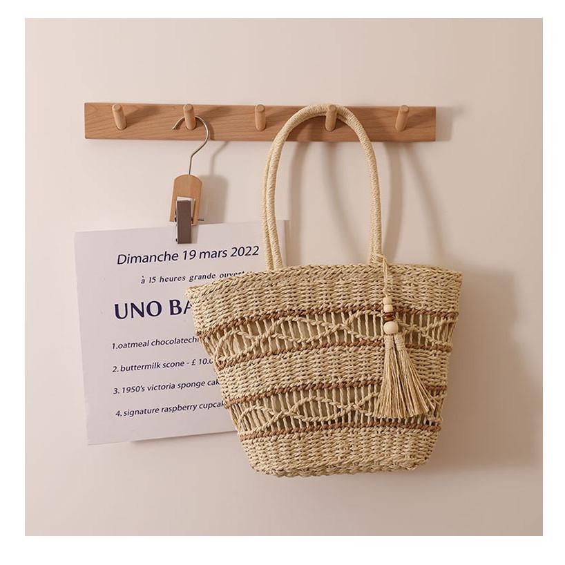 IELGY fashion hollow shoulder straw bag, fringed hand-woven holiday wind beach women's bag
