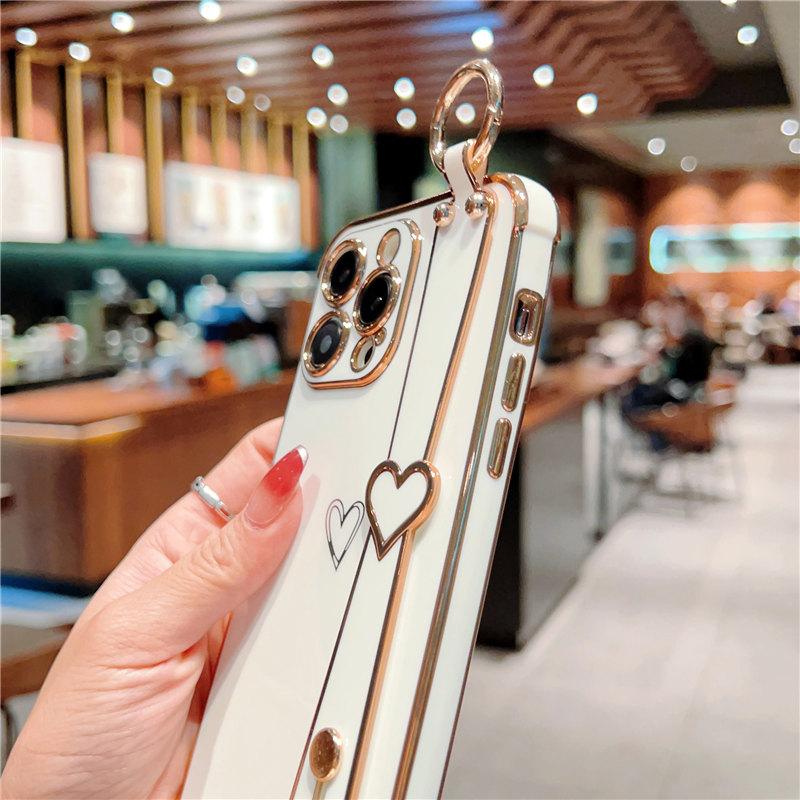 Funda para teléfono con correa de muñeca chapada para iPhone 14 13 12 11 Pro Max Xs Max Xr 13pro 14 Plus 11 a prueba de golpes suave parachoques amor corazón cubierta