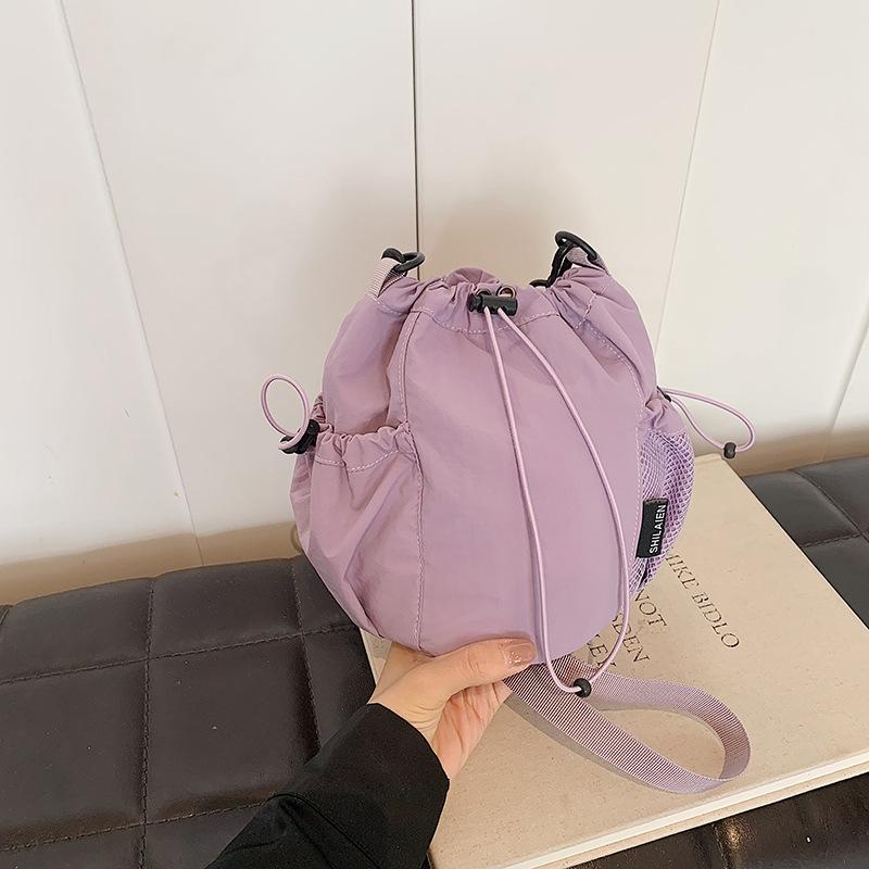 

Summer new Japanese and Korean niche drawstring bundle canvas shoulder messenger bag women s lightweight versatile lazy bucket bag фіолетовий