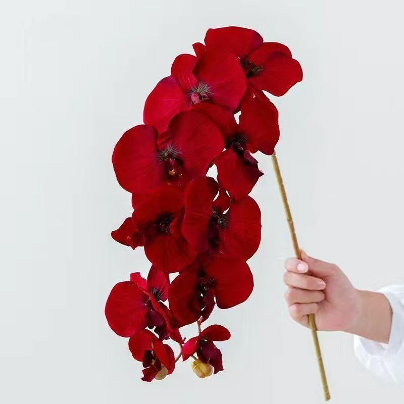 Kytice umělých orchidejí Phalaenopsis v elegantní váze pro dekoraci jídelního stolu a obývacího pokoje