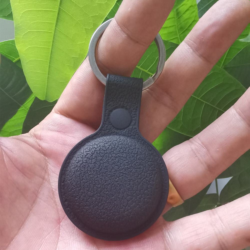 Apple AirTag silicone case with genuine leather texture for high-end fashion and premium protection.