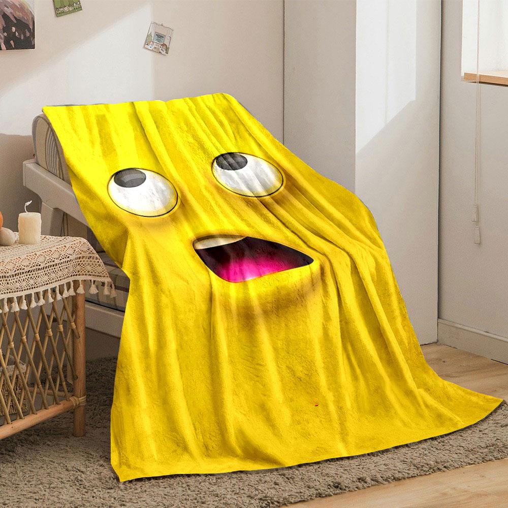 Bright yellow cartoon face with large eyes and an open mouth showing pink. for all seasons blanket lunch break throw gift