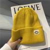 Cute smiley face label wool hat women's autumn and winter warm trend versatile ear protector black knitted hat men