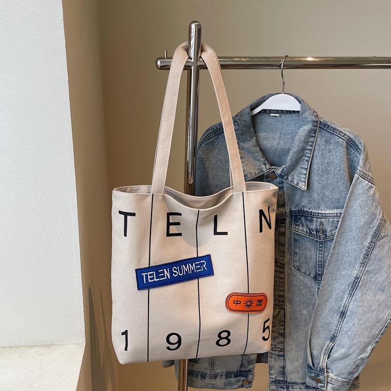 Mote Ny Myk Slitesterk Vintage Tote Stor Kapasitet Premium Tekstur Myk Slitesterk Bokstavtrykk Utendørs Pendler Enkel Skulder Crossbody Bøtteveske