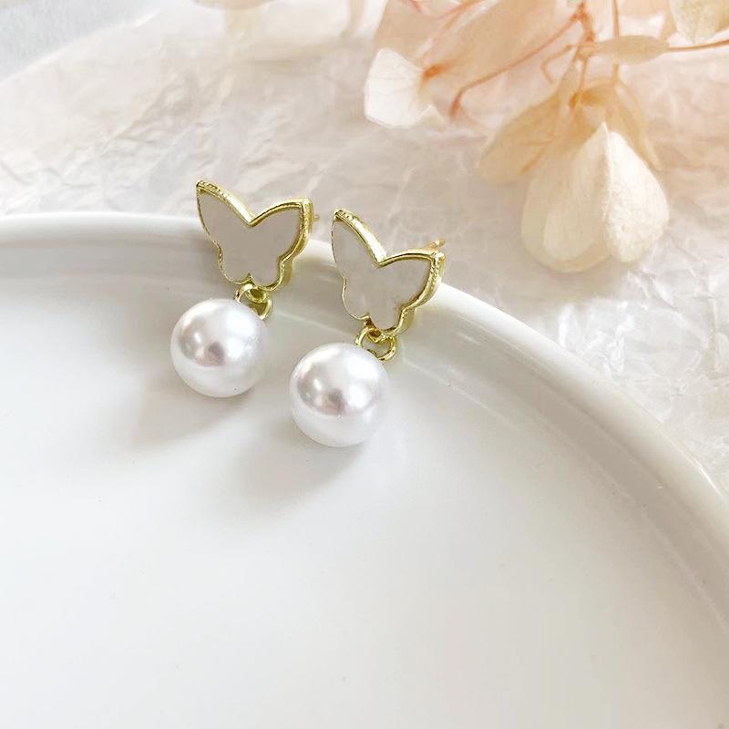Elegant Bow Pearl Dangle Earrings: Korean & Japanese Style, Light Luxury Fashion Studs for Women.