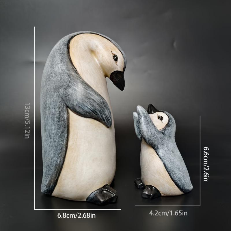 A Set of Two Resin Statues Featuring a Mother And Penguin Showcasing a Creative Family Theme These Can Serve As Decorative Pieces for Home