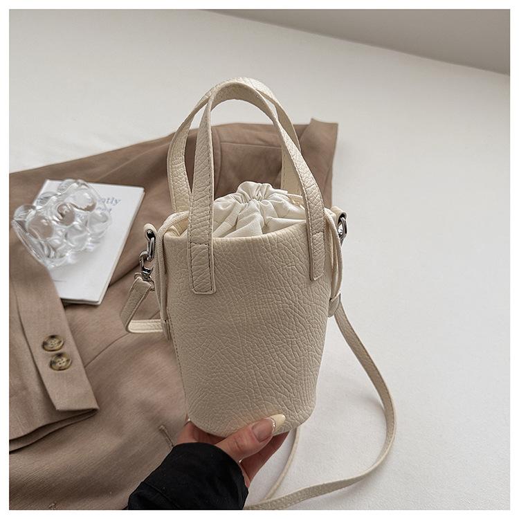 Niche foreign gas hand carrying bucket bag women s bag 2025 new foreign gas lychee pattern commuter small satchel fashion shoulder bag