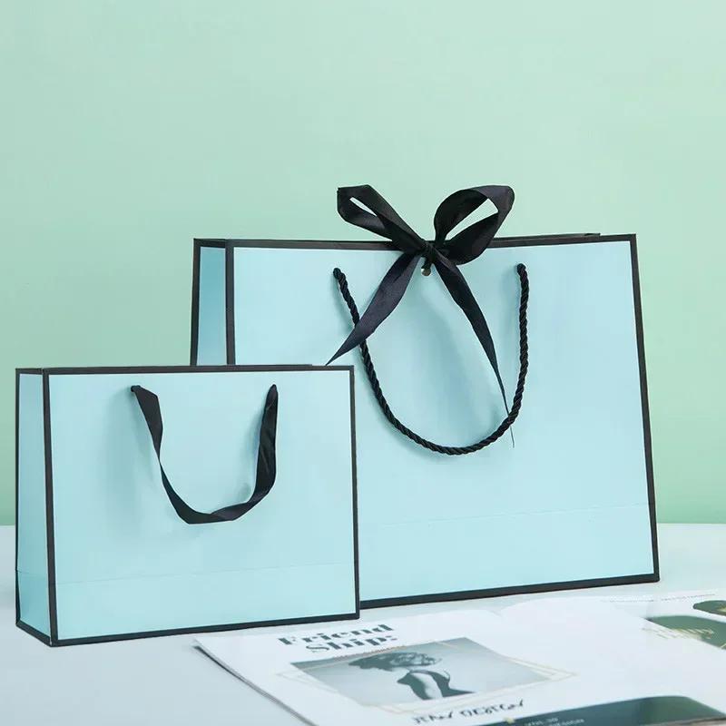White Paper Jam Handbag Kraft Paper Thick Waterproof Frame Rivet Handle Gift Bag Cosmetic Clothing Store Portable Packaging Bags