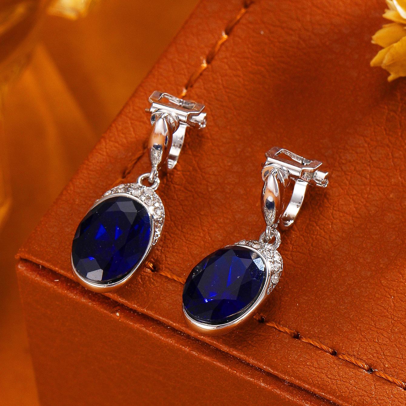 

Європейські та американські різнокольорові овальні скляні сережки без проколу з покриттям рожевим золотом та силіконовими заглушками