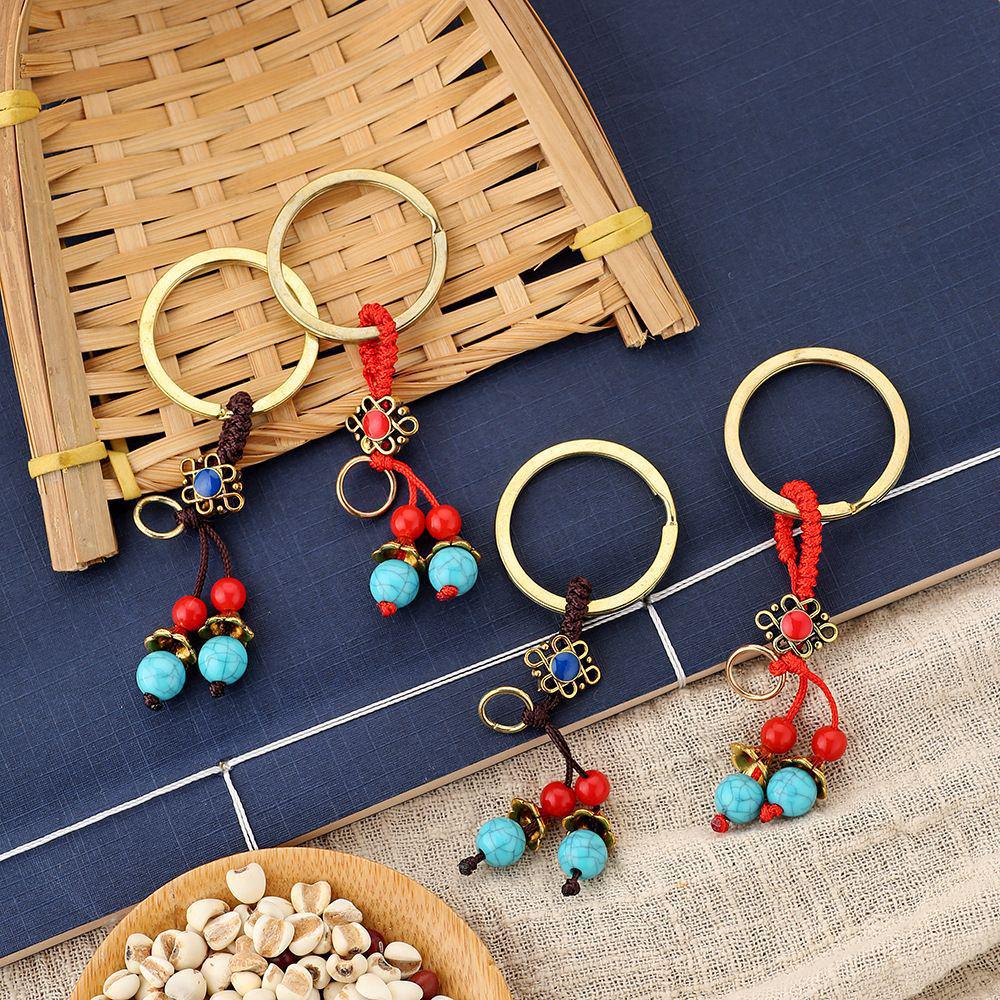 Breloc din alamă cu cei cinci împărați și pandantiv din frânghie galbenă și roșie