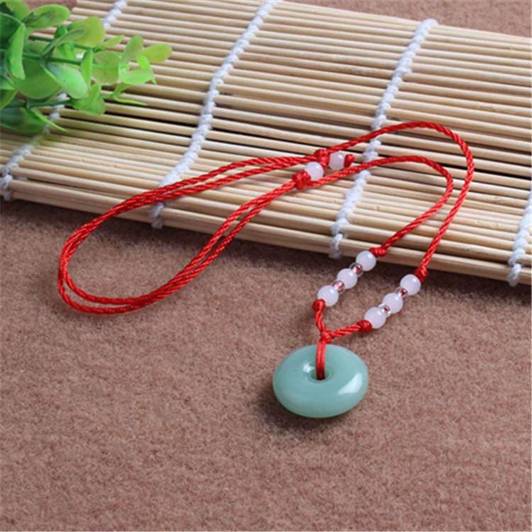 Hetian Jade Guanyin Buddha Pendant Necklace with Red String and Eight Bead Design.