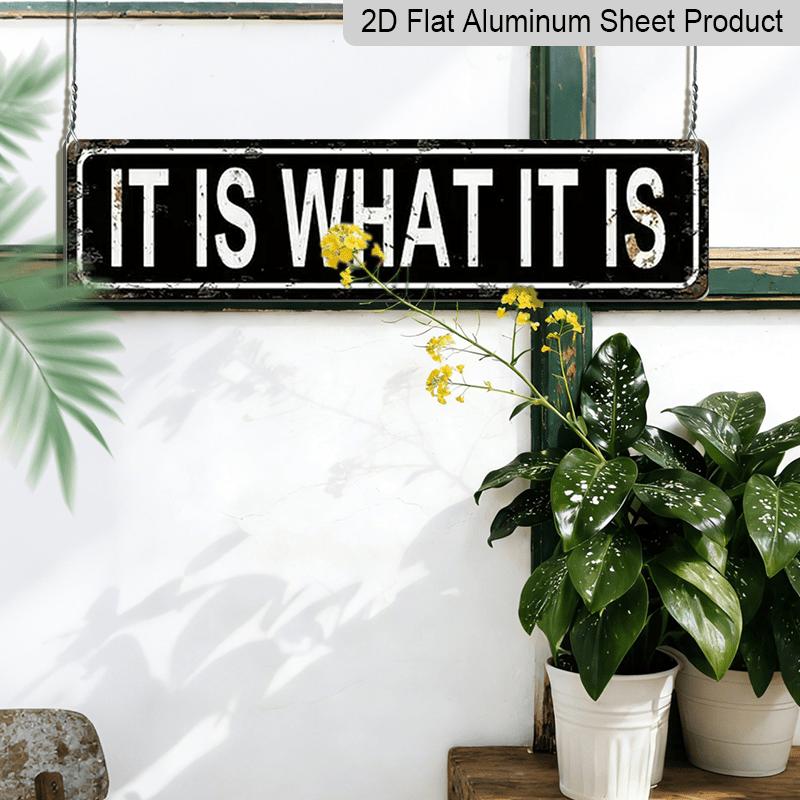 Metal Sign Featuring The Phrase 'IT IS WHAT IT IS' In A Rustic Style, Perfect for Vintage Wall Art In Your for Home, Garage, or Man Cave. This