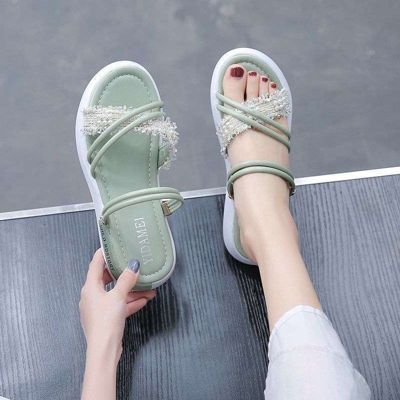 Two women wearing sandals in the summer of 2025, the new sports mid-heel wedge heel muffin thick-soled Roman pregnant women's flat-soled women's shoes