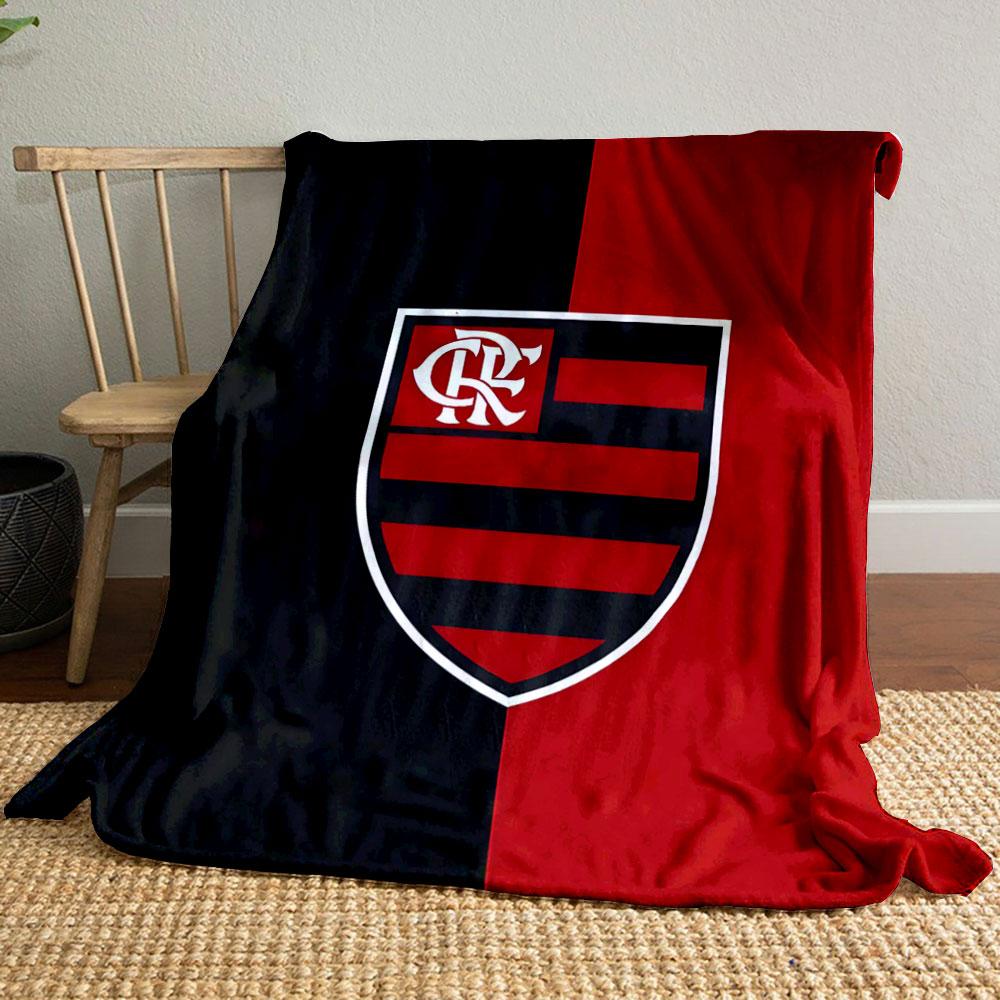 A vertically split black and red background with a striped shield emblem. for all seasons blanket lunch break throw gift