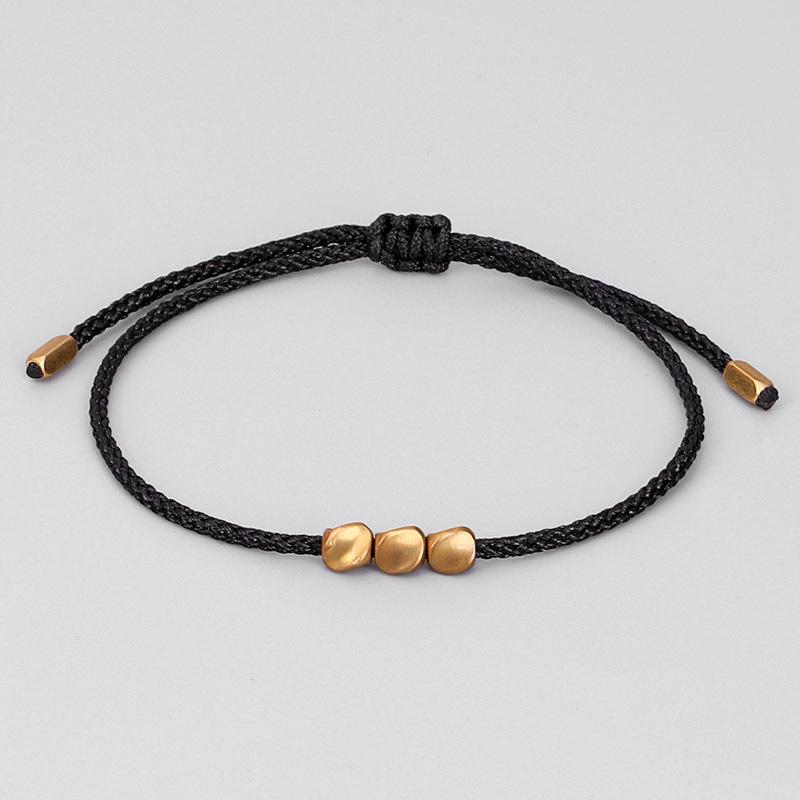 

Hand-Woven Red and Black String Bracelet with Irregular Copper Beads